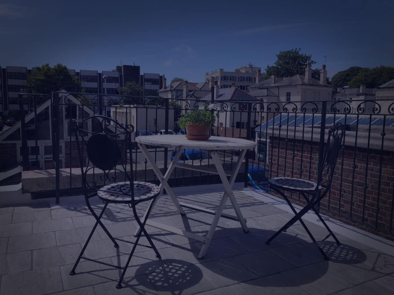 Black wrought iron style balcony railings on a roof terrace installed by The Handrail People West Sussex