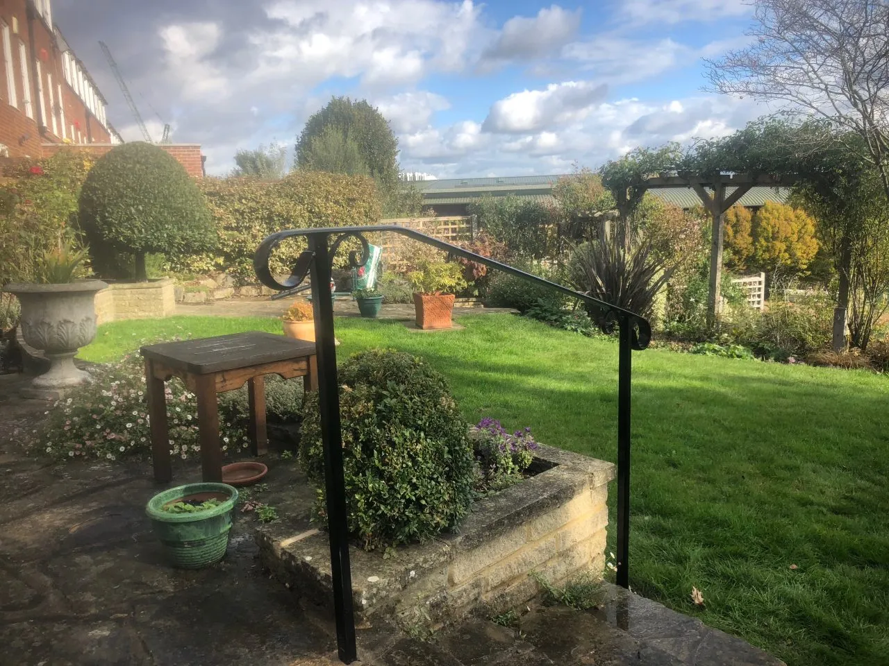 Black wrought iron style handrail fitted beside garden steps The Handrail People West Sussex